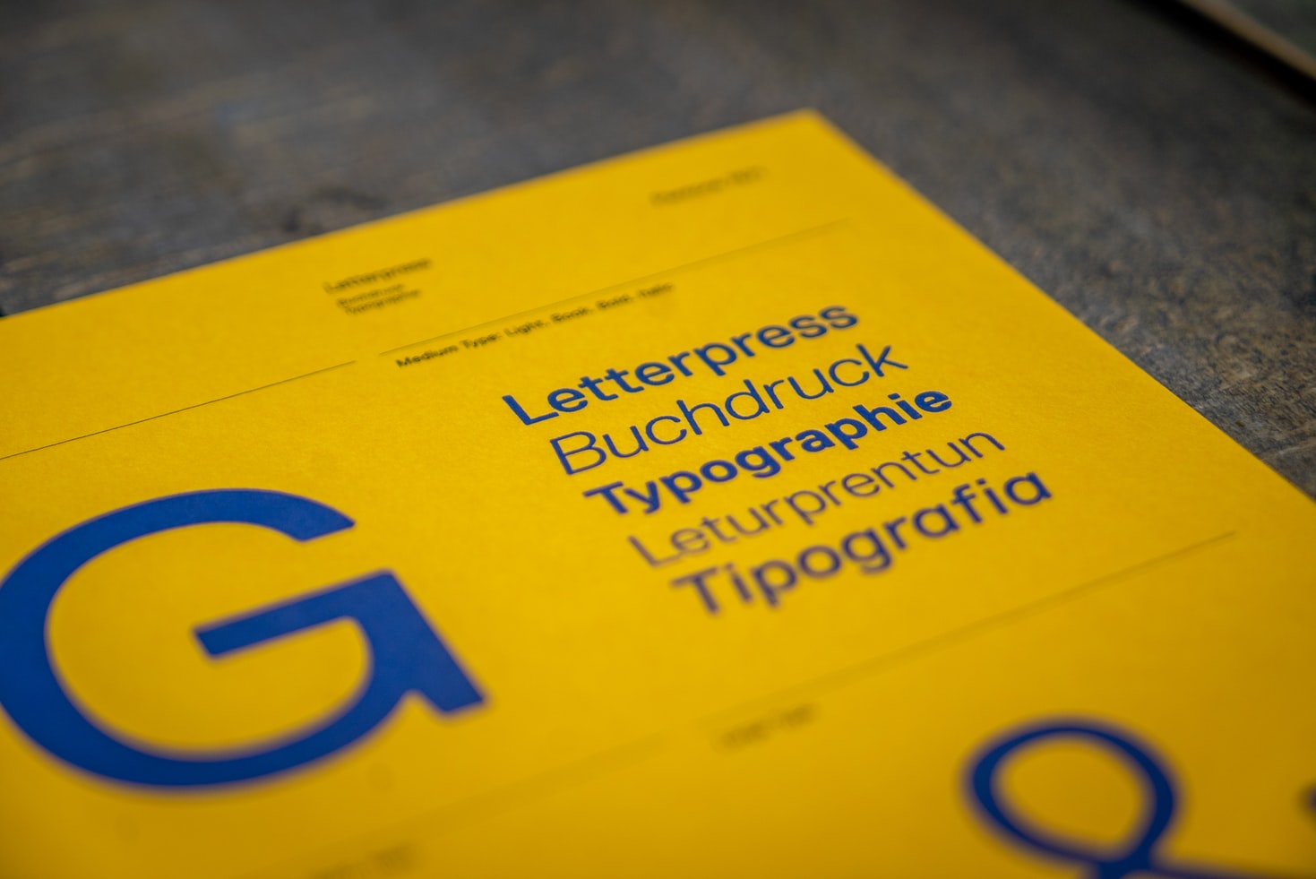 A bright yellow sheet featuring the word Typography in different languages
